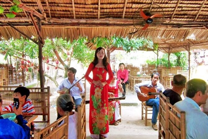 Adventure Cu Chi Tunnels and Mekong Delta Tour From HCM - Honey tea, fruit, coconut candy, and live folk music