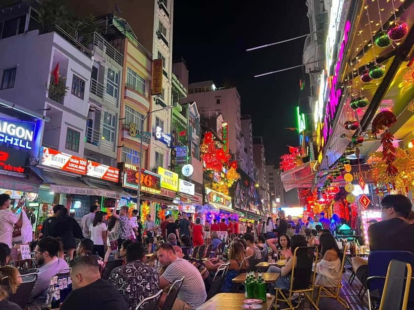 Ho Chi Minh City: Night Walking Tour with Hidden Gem Stop - The District 1 secret stop: a calmer pace and a drink included